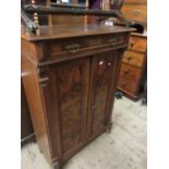 19th Century Swiss walnut side cabinet with a single drawer above two panel doors, raised on bun