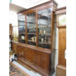 Early 20th Century mahogany three door bookcase, having three bar glazed doors enclosing