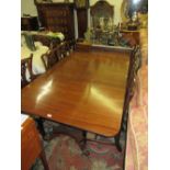 George IV style mahogany three pillar dining table on turned supports with platform bases and scroll