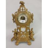 Gilt brass mantel clock mounted with figures together with a small Camerer Cuss and Co. mantel clock