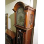 Mid 20th Century mahogany longcase clock with an arched hood above glazed door, raised on bracket