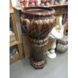 Large terracotta jardiniere on stand, simulated as brown marble.