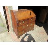 18th Century oak bureau with a fall front enclosing a fitted interior above two short and two long