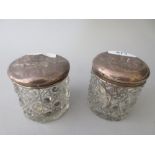 Pair of silver mounted cut glass dressing table jars embossed with Whispers design together with two