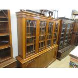 Reproduction yew wood four door bookcase, a matching breakfront sideboard and a matching dining