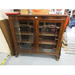 Early 20th Century mahogany display cabinet having gadroon moulded top above two bar glazed doors