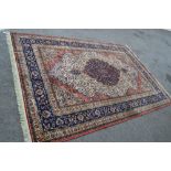 Machine woven rug of Persian design with a blue centre medallion on an ivory ground, 9ft 6ins x
