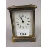 20th Century brass cased carriage clock having enamel dial with Roman numerals including winding