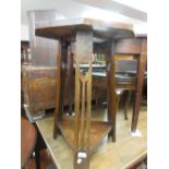 Arts and Crafts oak octagonal inlaid occasional table, the supports pierced with hearts, having