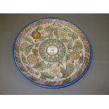 Crown Ducal Charlotte Rhead circular pottery charger with tube lined floral decoration, 12.5ins