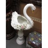 Modern pottery and floral encrusted jardiniere in the form of a swan on a similar stand