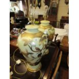 Pair of large floral decorated pottery table lamps with shades