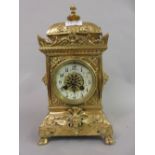 Late 19th / early 20th Century gilt brass cased mantel clock with an ornate relief work case, the