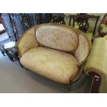 19th Century gilt sofa with bird and floral upholstery and carved decoration, raised on turned