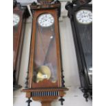 Burr walnut and ebonised Vienna style wall clock with circular enamel dial having Roman numerals,