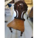 Pair of Victorian mahogany hall chairs, the shaped carved and pierced backs above shaped panel seats