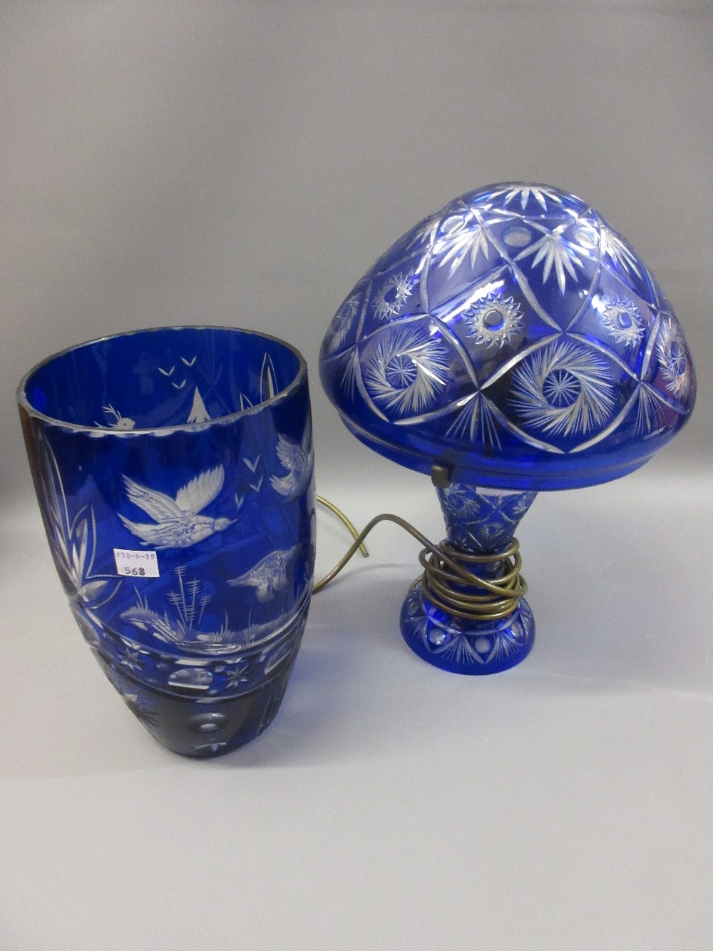 Bohemian blue overlay clear glass mushroom form table lamp, together with a similar vase engraved