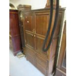 Oak bacon cupboard with moulded cornice above a pair of panelled doors with four fielded panels