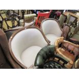 Pair of modern walnut framed tub shaped chairs with linen upholstery, loose cushions and raised on