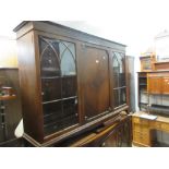 1920's Mahogany bookcase with a moulded top above a centre panelled door flanked by two glazed doors