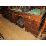 Early 20th Century mahogany twin pedestal desk with leather inset top above eight drawers with brass