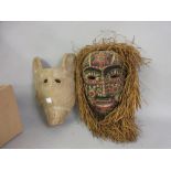 African painted wall mask together with another wall mask