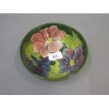 Moorcroft pottery pedestal bowl with floral decoration on dark green ground