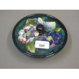 Moorcroft powder bowl and cover with floral decoration on dark blue ground