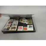 Album containing a collection of approximately five hundred World postage stamps