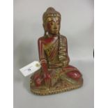 Eastern carved and gilded figure of seated Buddha with applied decoration, 11ins high