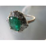 18ct White gold emerald and diamond ring set with a central oval shaped emerald of approximately 1.