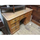 Victorian satin birch writing desk / dressing table, the beige leather inset top above seven drawers