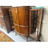 Good quality early to mid 20th Century walnut cocktail / display cabinet, the semi bow front with