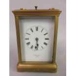 Early 20th Century matt gilded brass cased carriage clock, the enamel dial with Roman numerals,