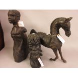 Two native carved hardwood figures, together with a patinated metal figure of a horse