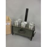 Childs 1920's spirit burner cooker in the form of a range with various pots and pans