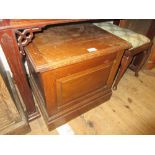 Early 20th Century oak commode with hinged cover and panelled front on plinth base