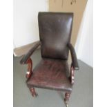 Victorian mahogany and dark tan leather upholstered open arm library chair on turned front