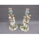 Pair of 19th Century French porcelain figural candlesticks (some damages), 14ins high