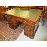 19th Century mahogany green leather inset desk having an arrangement of nine drawers with knob