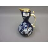 19th Century Mintons jug vase having white enamelled floral decoration on a dark blue ground, 8.5ins