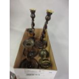 Two pairs of 1930's wooden candlesticks, a nutcracker in the form of a ships wheel and a brass bell