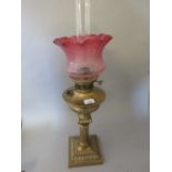 Brass Corinthian column oil lamp with etched cranberry glass shade Shade good, chips to base of