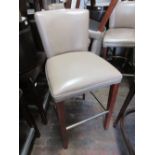 Set of four simulated leather biscuit covered bar stools on square tapering legs with steel bar