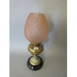 Victorian brass oil lamp with a pink frosted glass shade