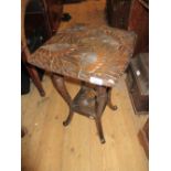 Floral carved square two tier occasional table with shaped supports and a child's ladder back rush