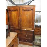Victorian mahogany linen press with a pair of arched doors above two short and two long drawers on a