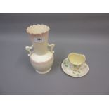 Belleek clover decorated cup and saucer and a late Belleek two handled baluster form vase