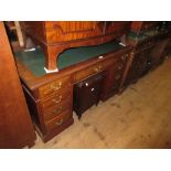 Late 19th or early 20th Century mahogany twin pedestal desk with a green inset top, nine drawers,