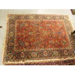 Tabriz rug of all-over floral design with five rows of gols on a wine ground, 56ins x 80ins